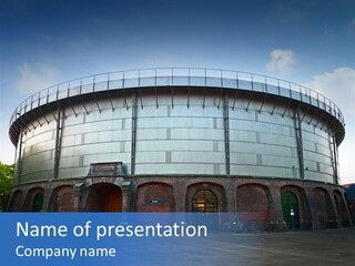A Large Round Building With A Metal Roof PowerPoint Template
