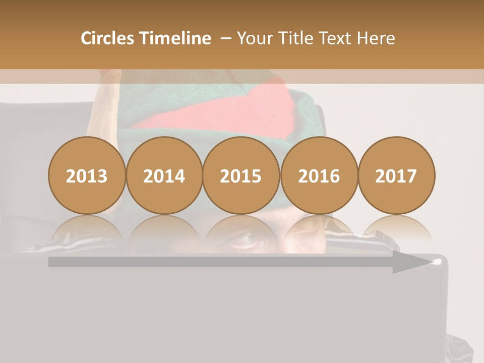 A Man Wearing A Elf Hat Sitting In Front Of A Laptop PowerPoint Template