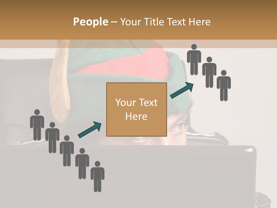 A Man Wearing A Elf Hat Sitting In Front Of A Laptop PowerPoint Template