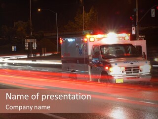 An Ambulance Driving Down A City Street At Night PowerPoint Template