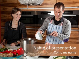 A Man And Woman Preparing Food In A Kitchen PowerPoint Template