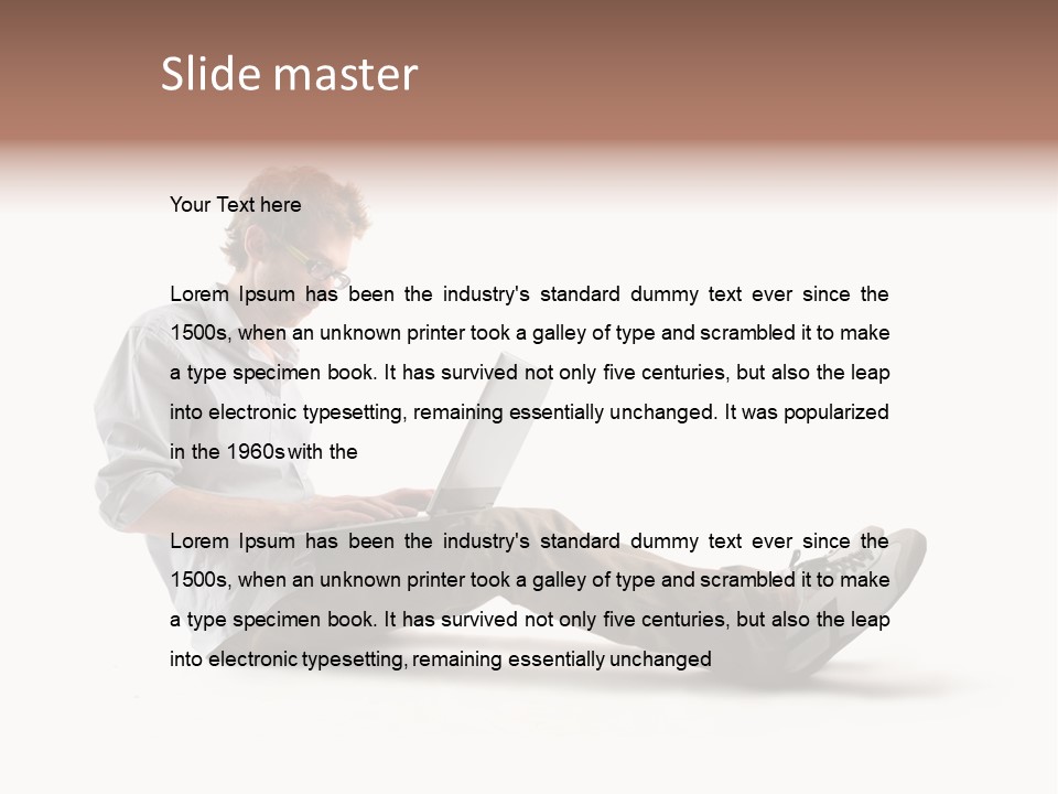 A Man Sitting On The Floor Using A Laptop Computer PowerPoint Template