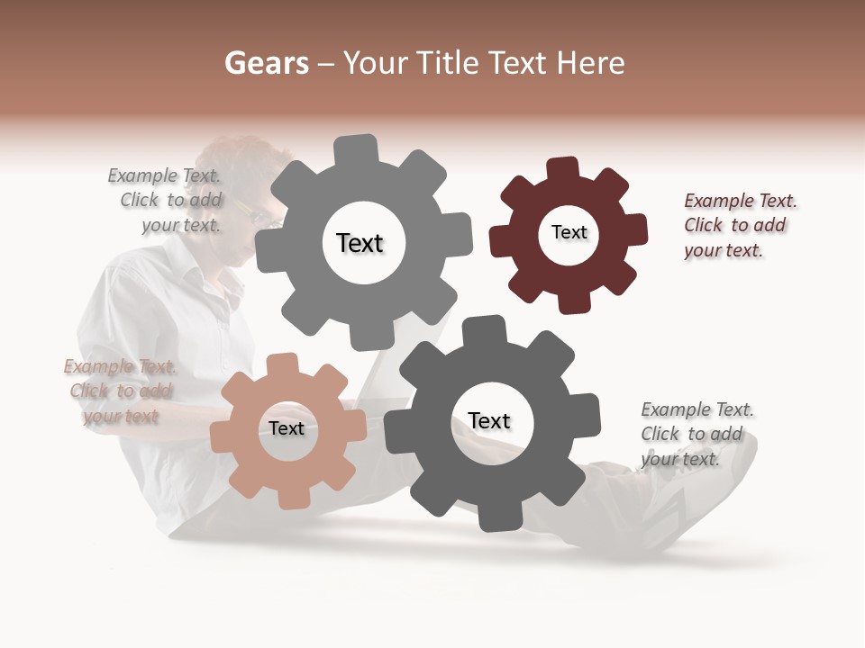 A Man Sitting On The Floor Using A Laptop Computer PowerPoint Template