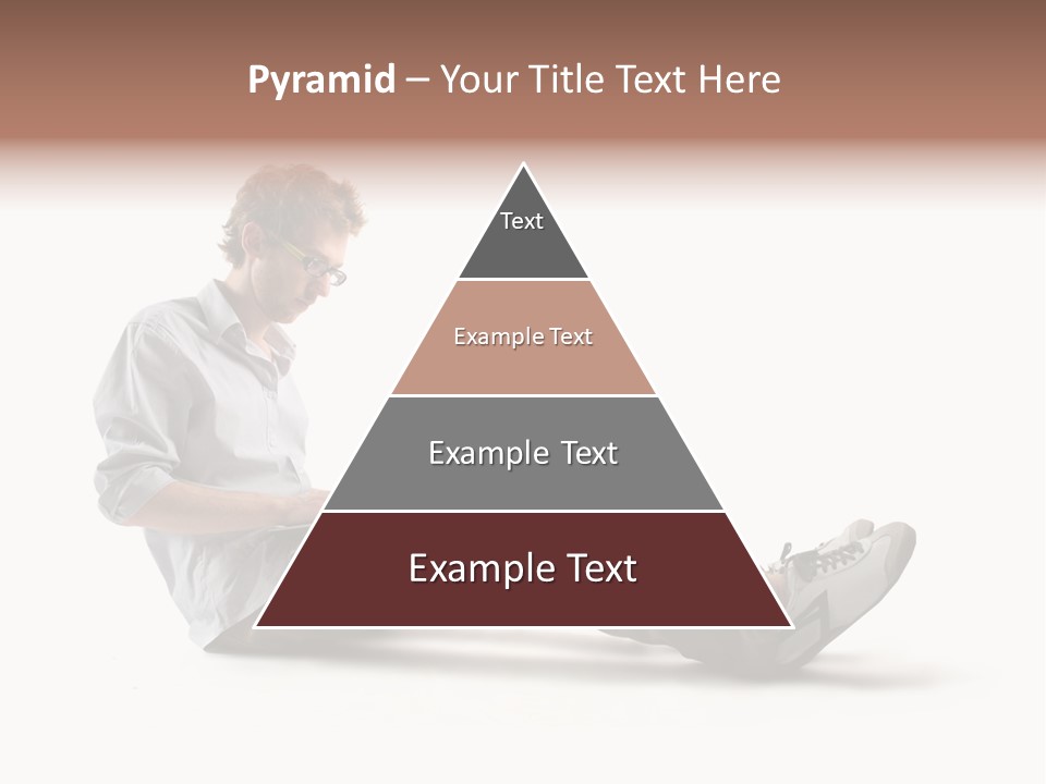 A Man Sitting On The Floor Using A Laptop Computer PowerPoint Template