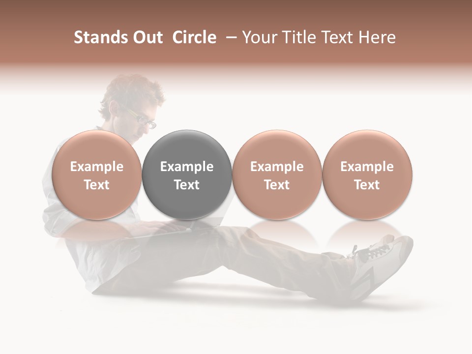 A Man Sitting On The Floor Using A Laptop Computer PowerPoint Template