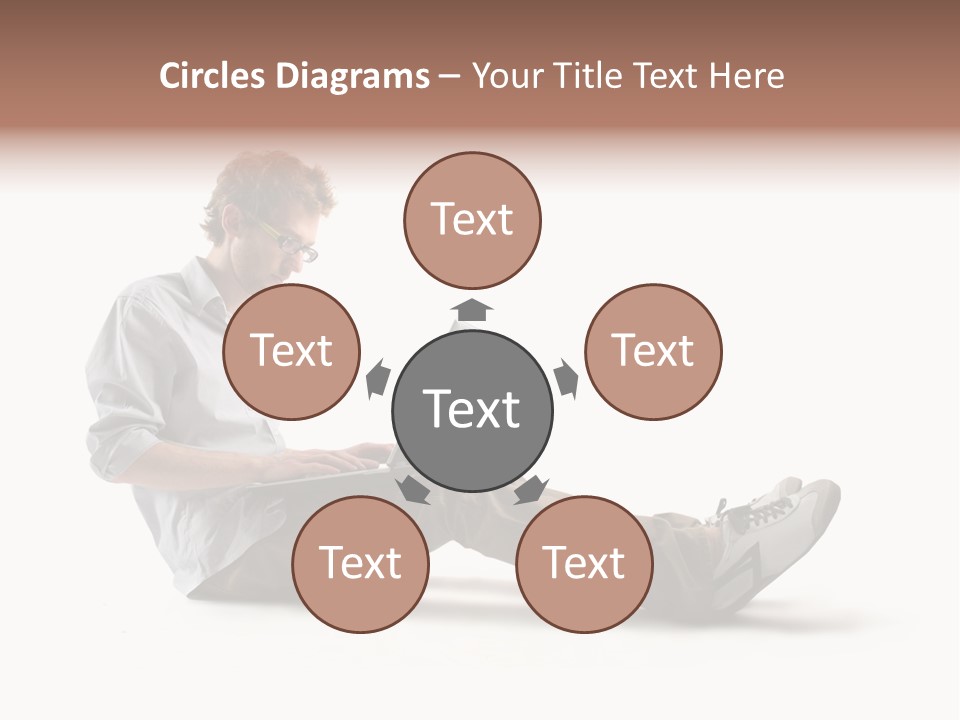 A Man Sitting On The Floor Using A Laptop Computer PowerPoint Template