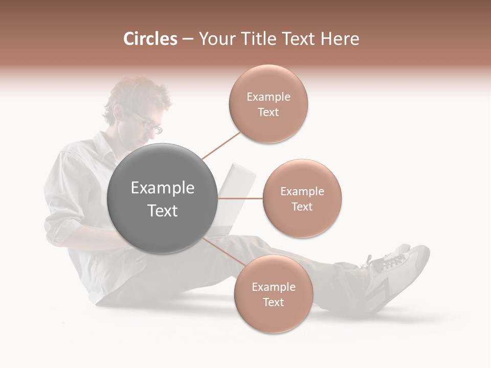 A Man Sitting On The Floor Using A Laptop Computer PowerPoint Template