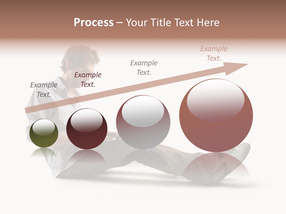 A Man Sitting On The Floor Using A Laptop Computer PowerPoint Template