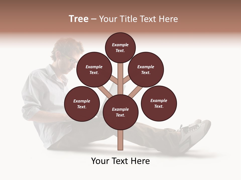 A Man Sitting On The Floor Using A Laptop Computer PowerPoint Template