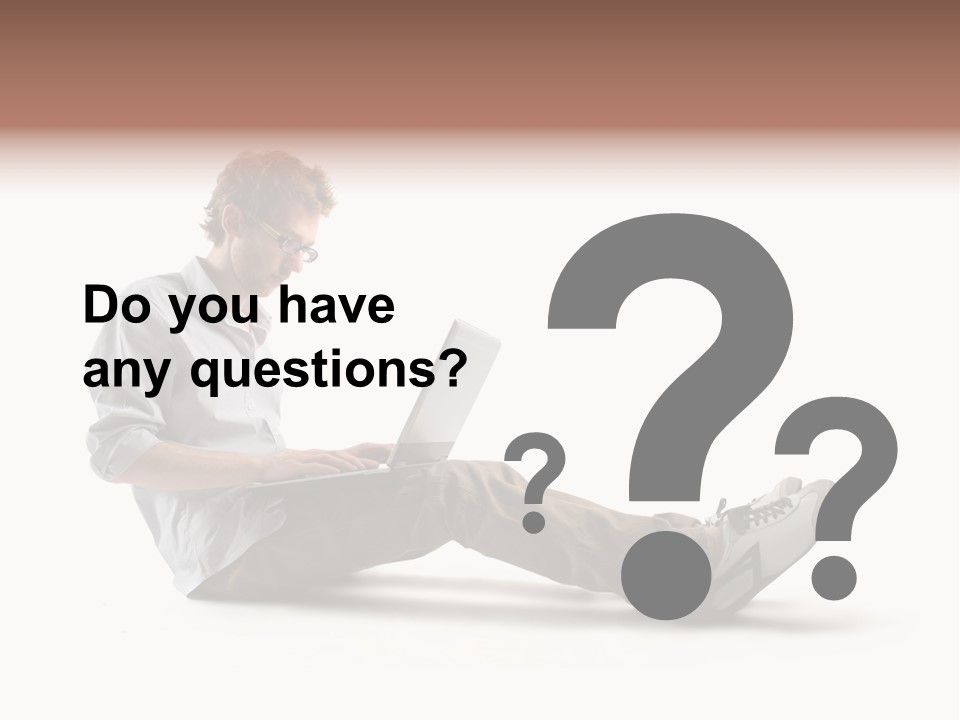 A Man Sitting On The Floor Using A Laptop Computer PowerPoint Template