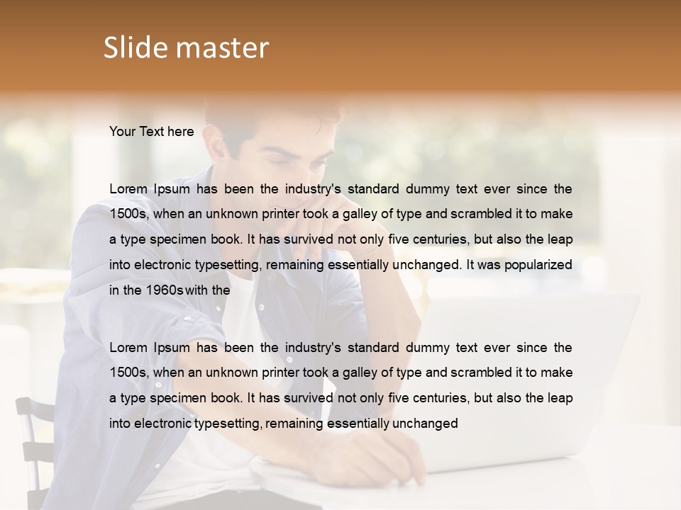 A Man Sitting In Front Of A Laptop Computer PowerPoint Template