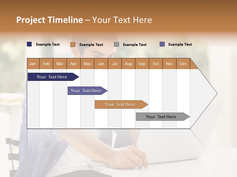 A Man Sitting In Front Of A Laptop Computer PowerPoint Template