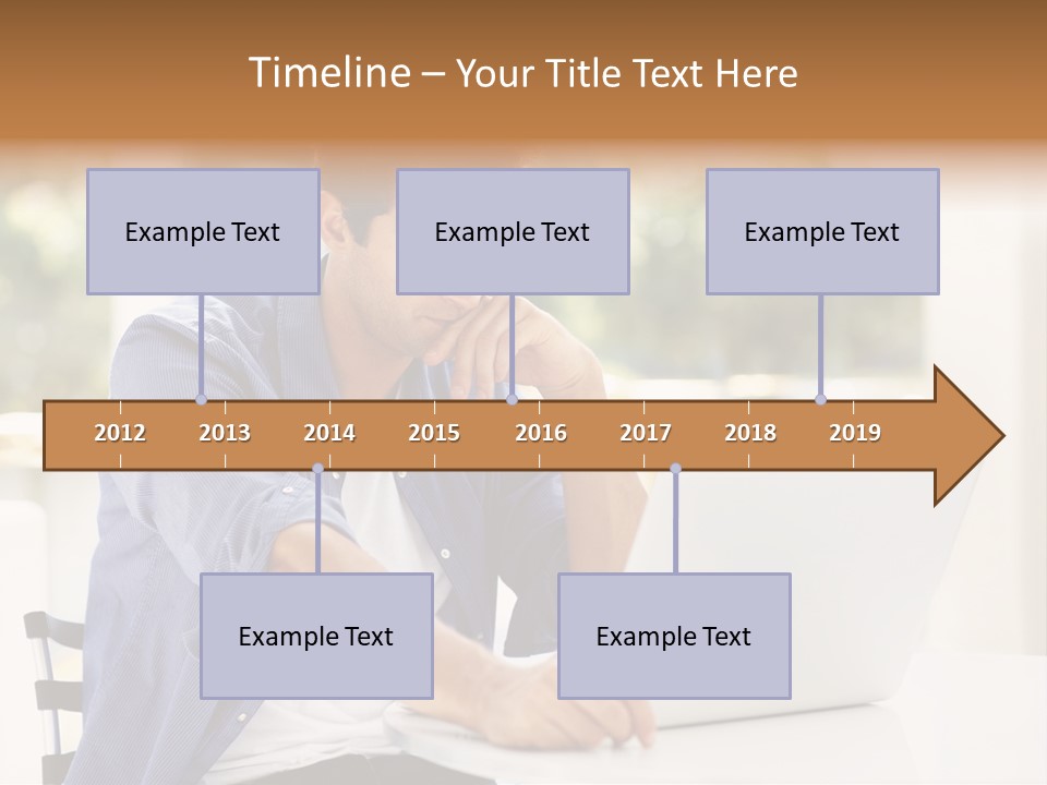 A Man Sitting In Front Of A Laptop Computer PowerPoint Template