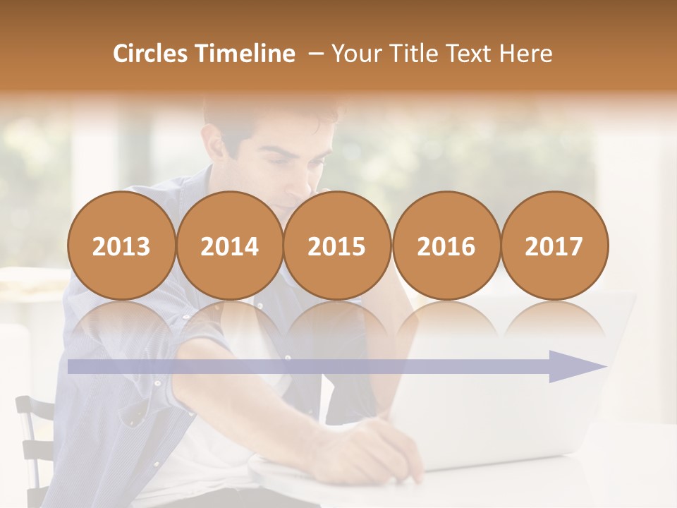 A Man Sitting In Front Of A Laptop Computer PowerPoint Template