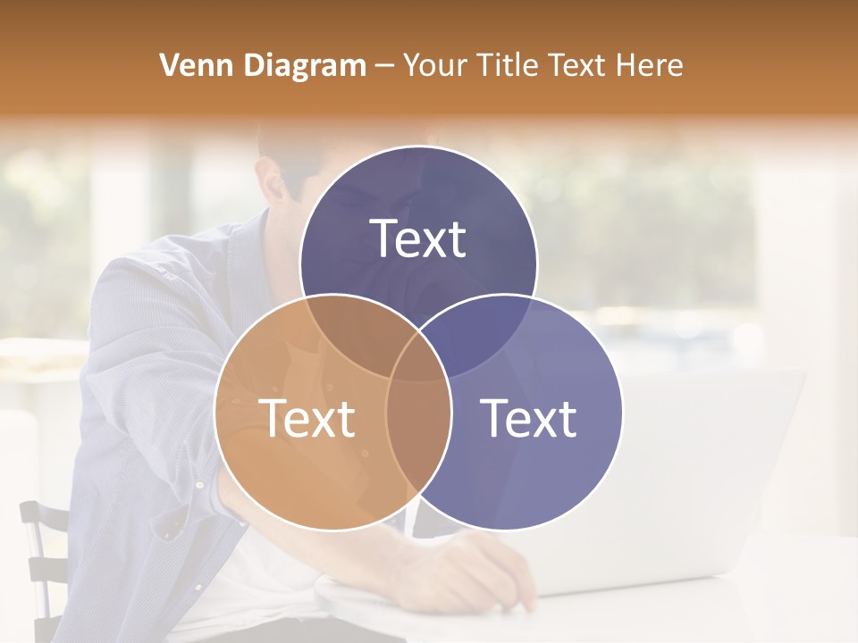 A Man Sitting In Front Of A Laptop Computer PowerPoint Template