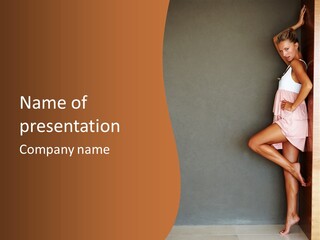 A Woman In A Pink Dress Leaning Against A Wall PowerPoint Template