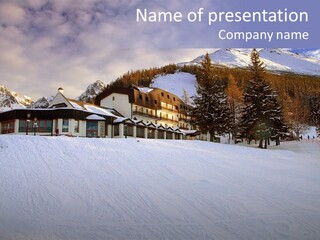 A Snow Covered Ski Slope With A Building In The Background PowerPoint Template