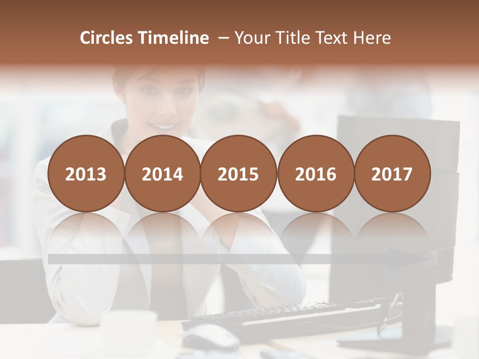 A Woman Sitting At A Desk In Front Of A Computer PowerPoint Template