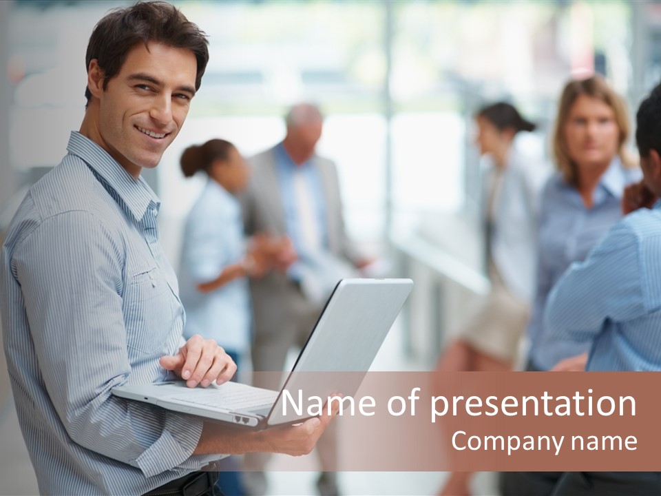 A Man Holding A Laptop In Front Of A Group Of People PowerPoint Template