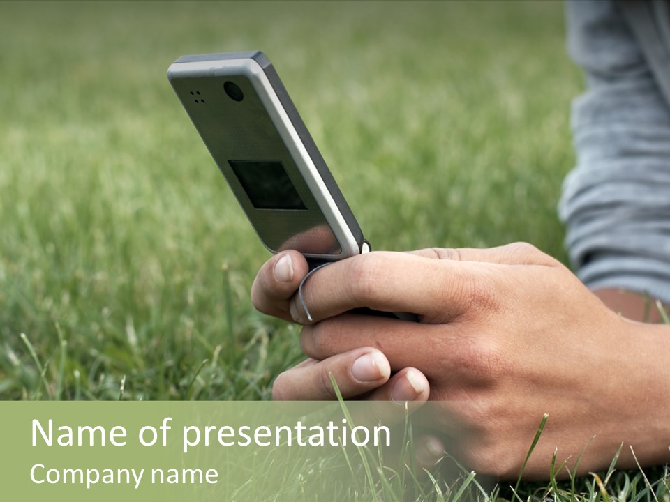 A Person Using A Cell Phone In The Grass PowerPoint Template