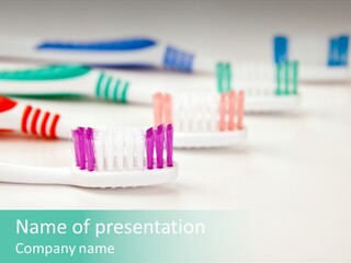 A Group Of Toothbrushes Sitting On Top Of A Table PowerPoint Template