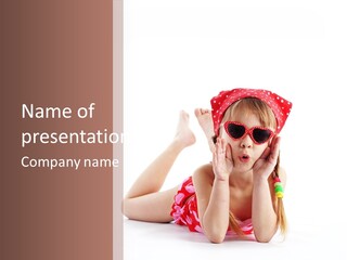 A Little Girl Laying On The Ground Wearing Sunglasses And A Red Hat PowerPoint Template