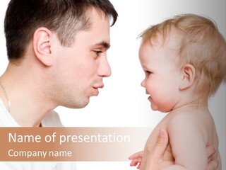 A Man Holding A Baby In His Arms PowerPoint Template