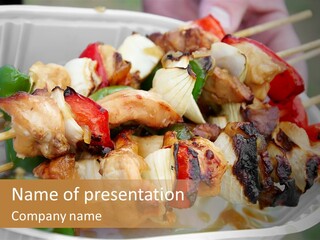 A Person Holding A Plate Of Food With Skewers PowerPoint Template