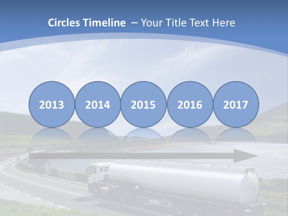 A Tanker Truck Driving Down A Road Next To A Lake PowerPoint Template