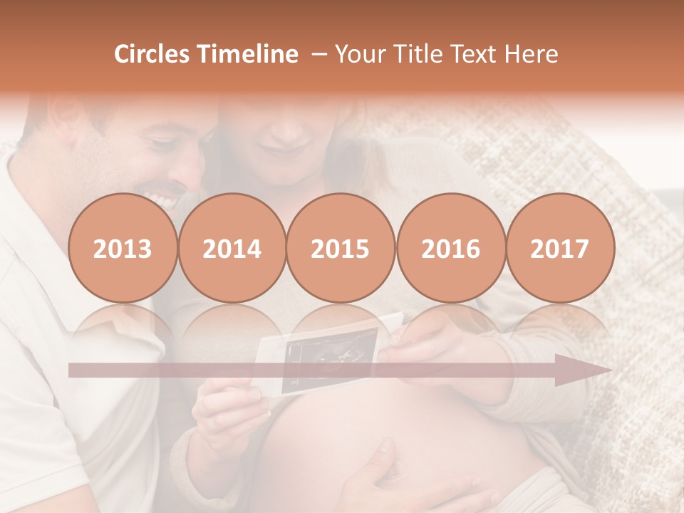 A Man And Woman Sitting On A Couch Looking At A Picture PowerPoint Template