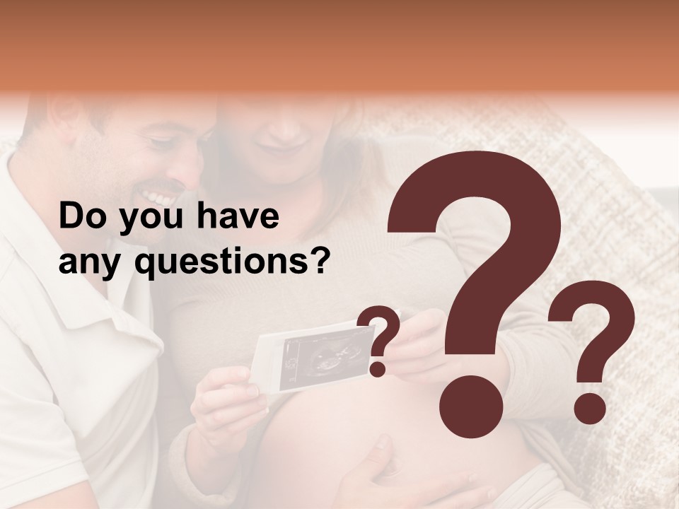 A Man And Woman Sitting On A Couch Looking At A Picture PowerPoint Template