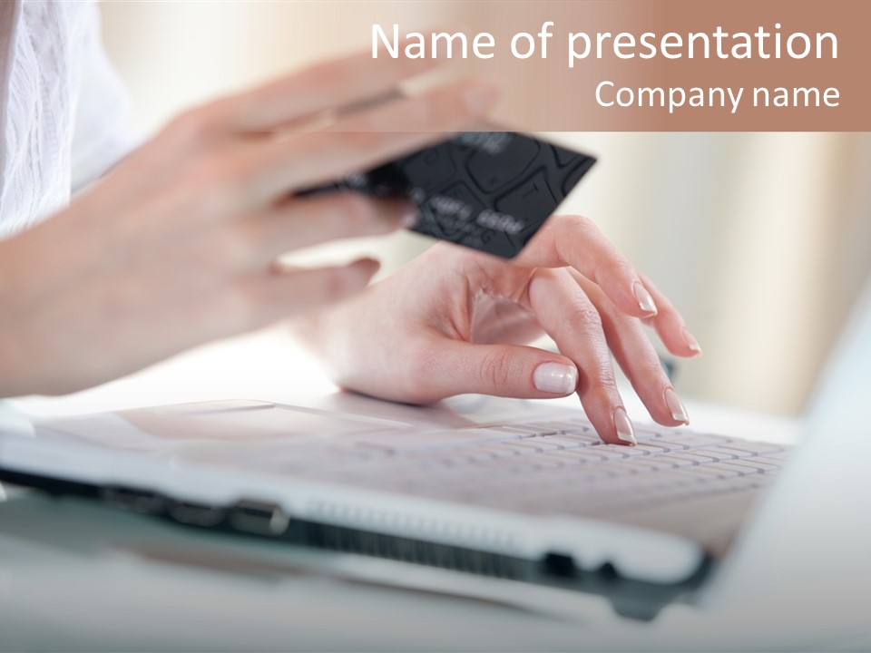 A Woman Holding A Credit Card While Typing On A Laptop PowerPoint Template