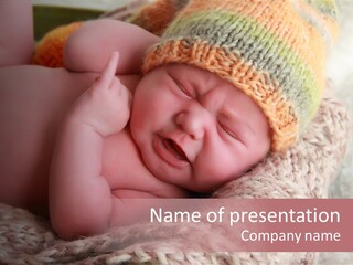 A Baby Wearing A Knitted Hat Laying On Top Of A Blanket PowerPoint Template