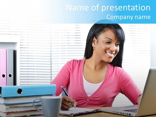 A Woman Sitting At A Desk With A Laptop PowerPoint Template