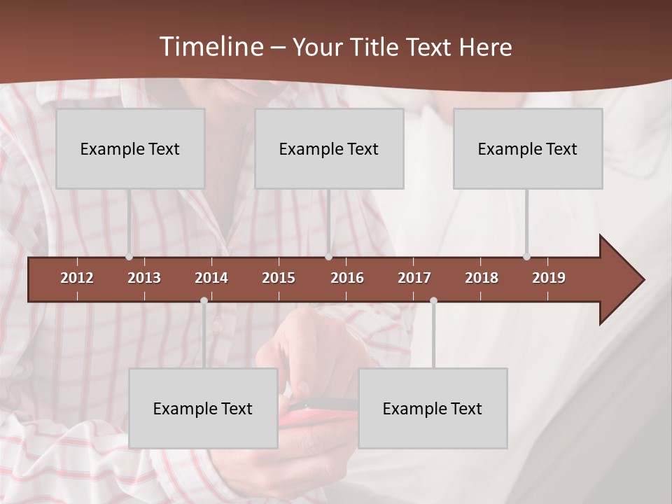 A Man Sitting On A Bed Looking At His Cell Phone PowerPoint Template
