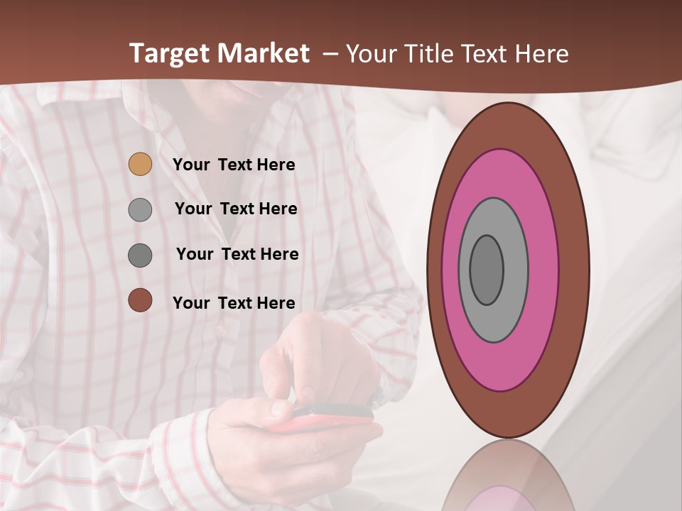 A Man Sitting On A Bed Looking At His Cell Phone PowerPoint Template