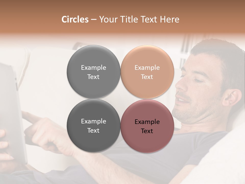 A Man Sitting On A Couch Looking At A Tablet PowerPoint Template