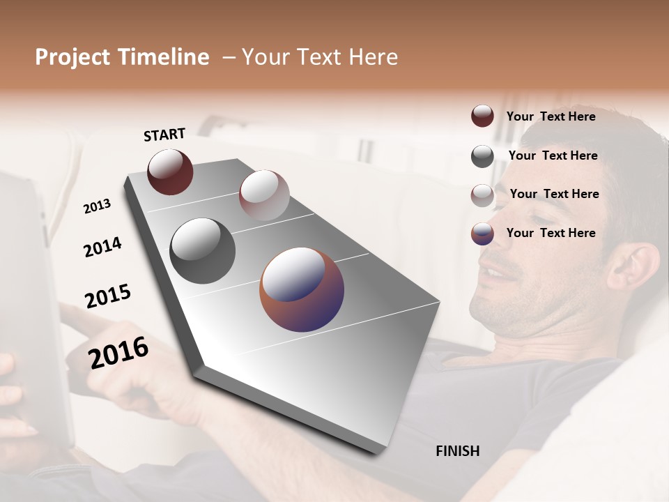 A Man Sitting On A Couch Looking At A Tablet PowerPoint Template