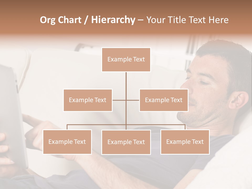 A Man Sitting On A Couch Looking At A Tablet PowerPoint Template