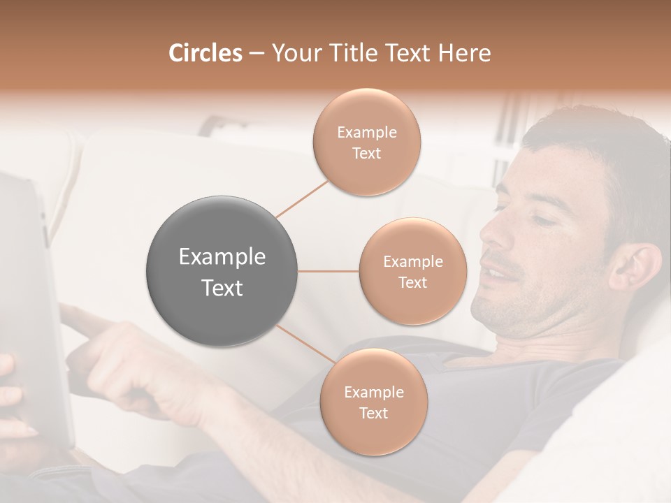 A Man Sitting On A Couch Looking At A Tablet PowerPoint Template