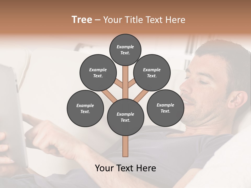 A Man Sitting On A Couch Looking At A Tablet PowerPoint Template