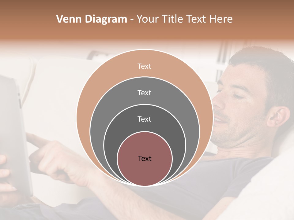 A Man Sitting On A Couch Looking At A Tablet PowerPoint Template