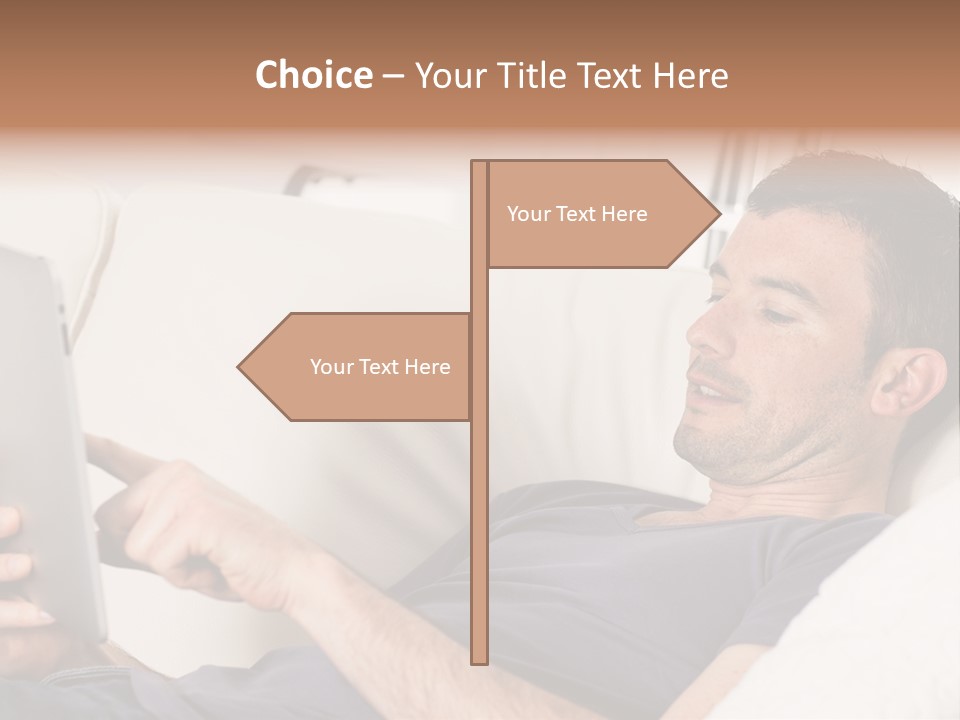 A Man Sitting On A Couch Looking At A Tablet PowerPoint Template