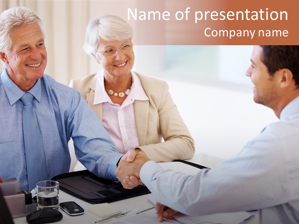 A Group Of People Shaking Hands At A Table PowerPoint Template