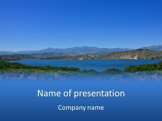 A Blue Lake With Mountains In The Background PowerPoint Template