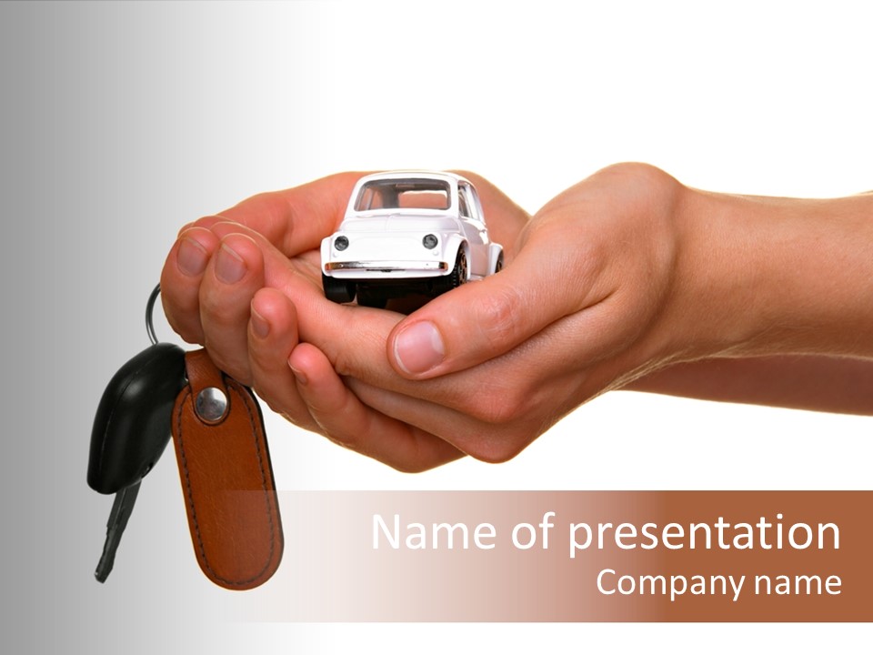 A Person Holding A Car Key In Their Hand PowerPoint Template
