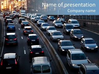 A Highway Filled With Lots Of Traffic Next To A Tall Building PowerPoint Template