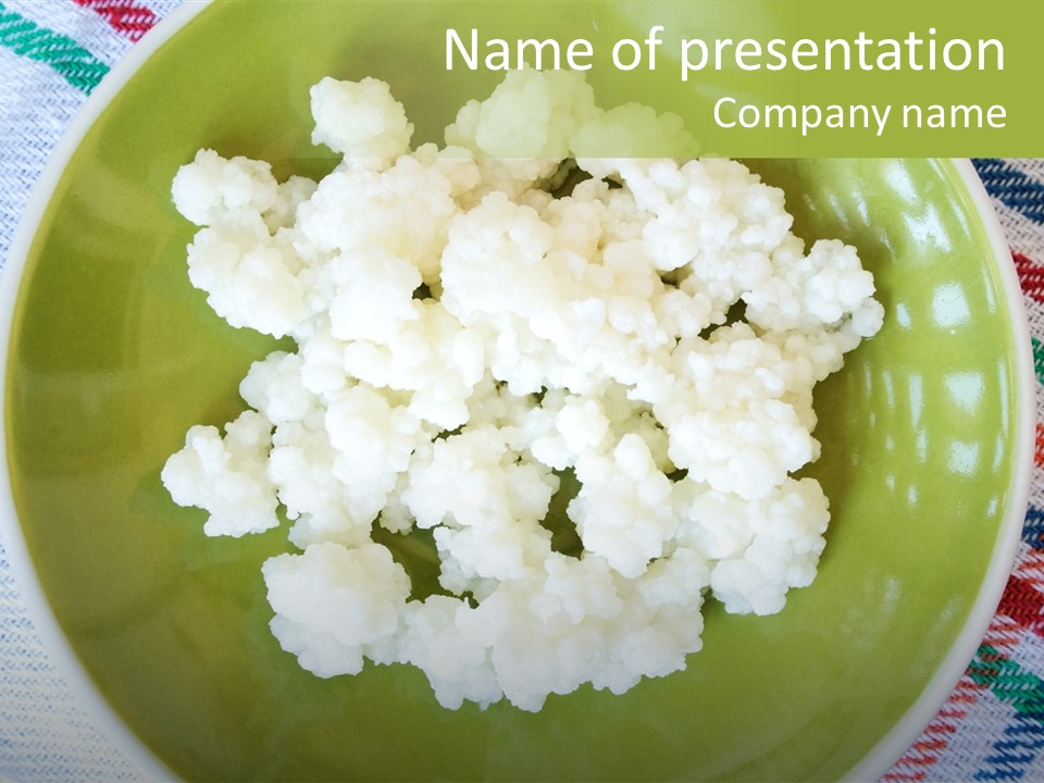 A Green Plate Topped With Cauliflower On Top Of A Table PowerPoint Template
