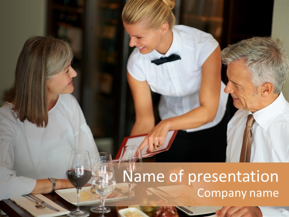 A Group Of People Sitting Around A Table PowerPoint Template