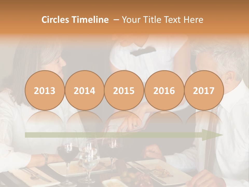 A Group Of People Sitting Around A Table PowerPoint Template